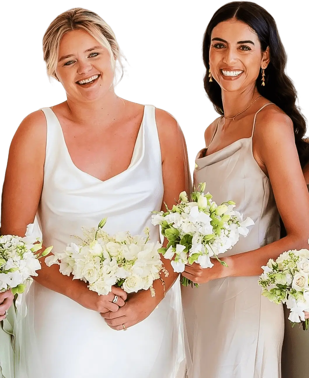 Two brides in elegant white dresses holding bouquets and smiling.